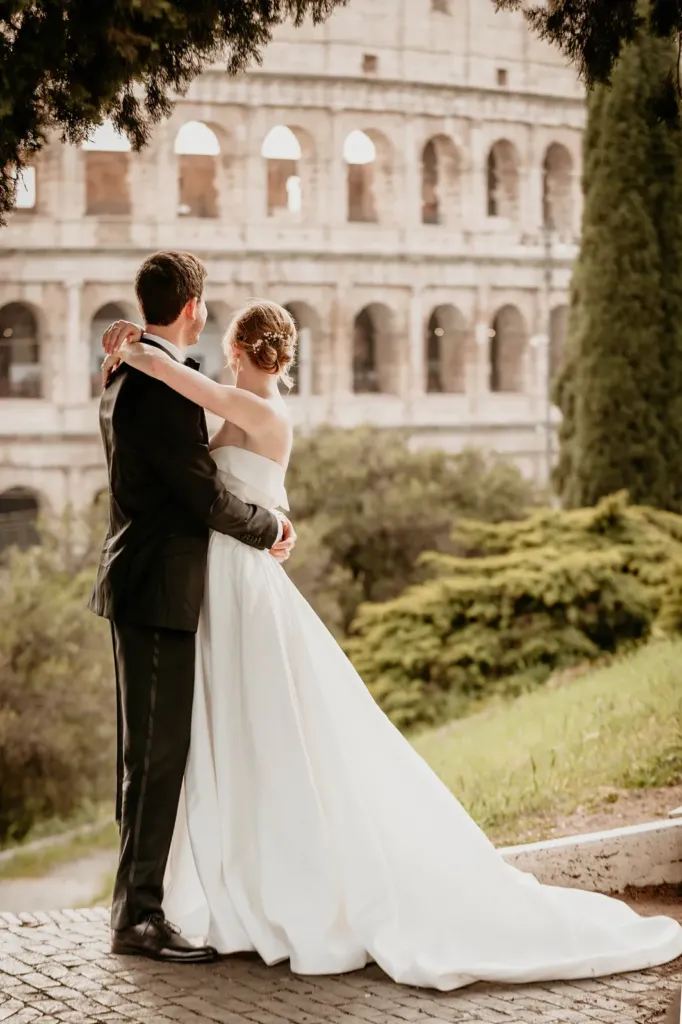 Bride and groom embracing in front of the Colosseum, Rome