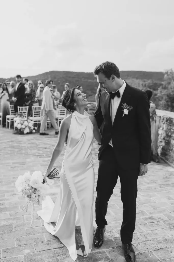 Just married bride and groom smiling after the ceremony, black and white, Italy